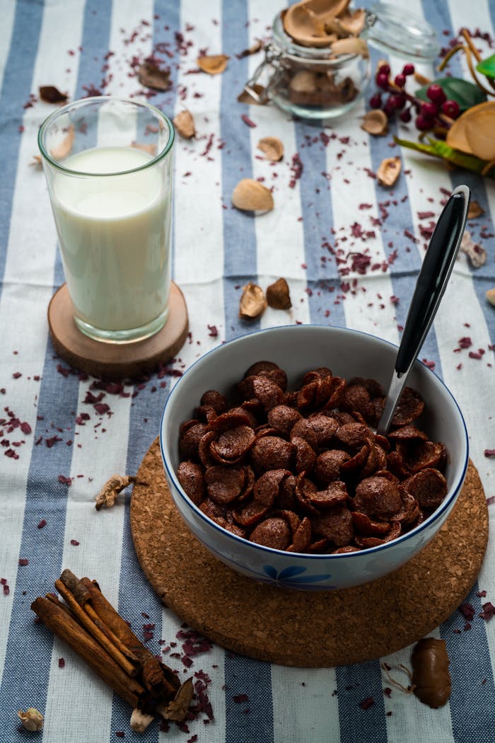 Delicious breakfast with chocolate cornflakes and milk glass